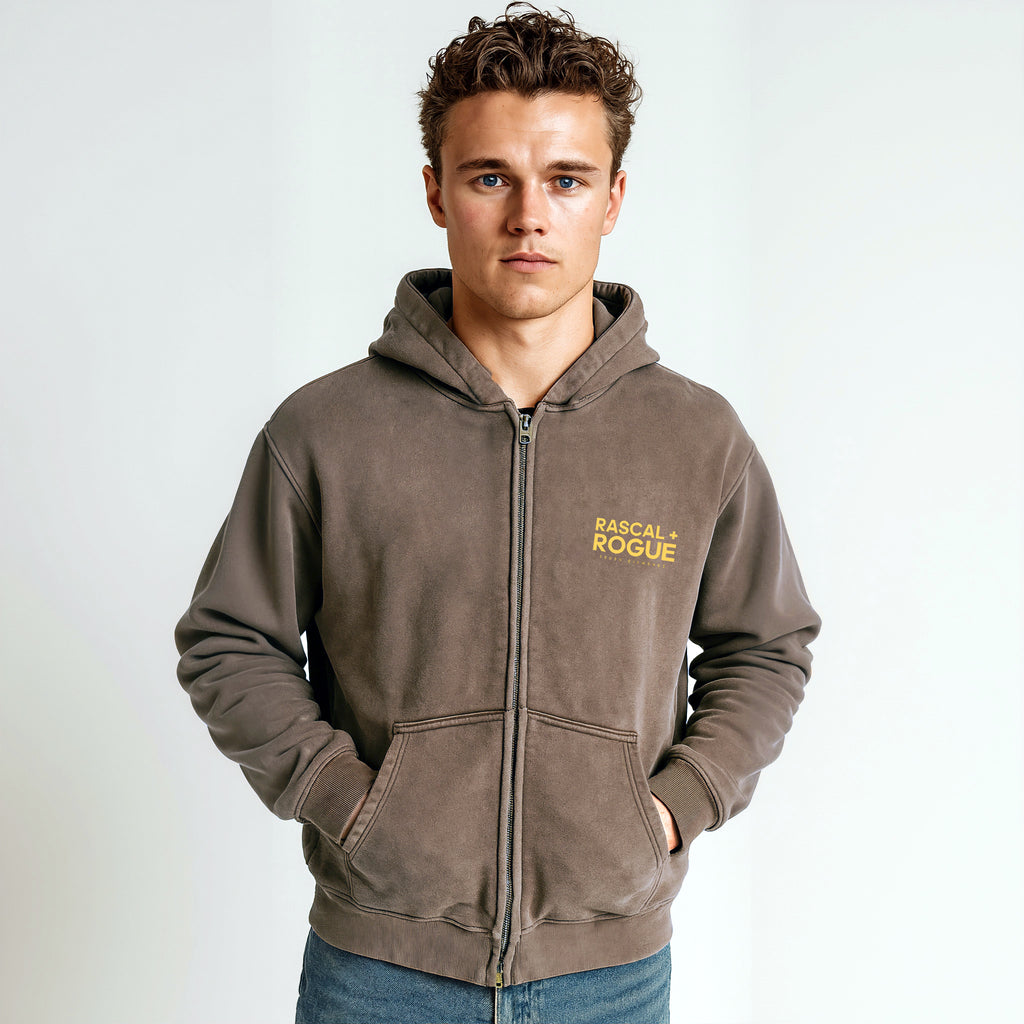 Man wearing a brown hoodie with 'Rascal Rogue' logo on a white background
